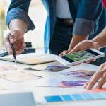 Advertising agency designer creative start-up team discussing ideas in office.