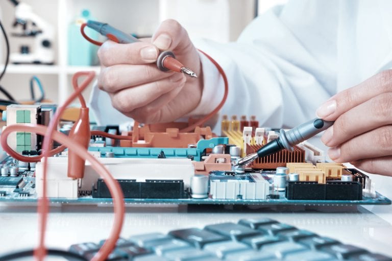 Electronics repair service, hands of female tech reparing an electronic circuit